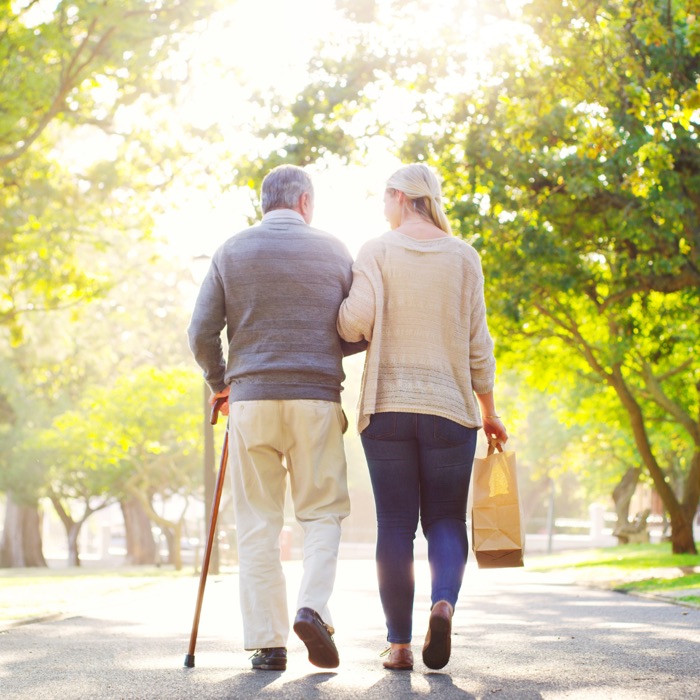 An older couple walking together in the park